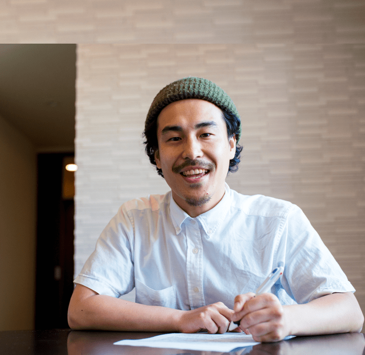 man writing on paper